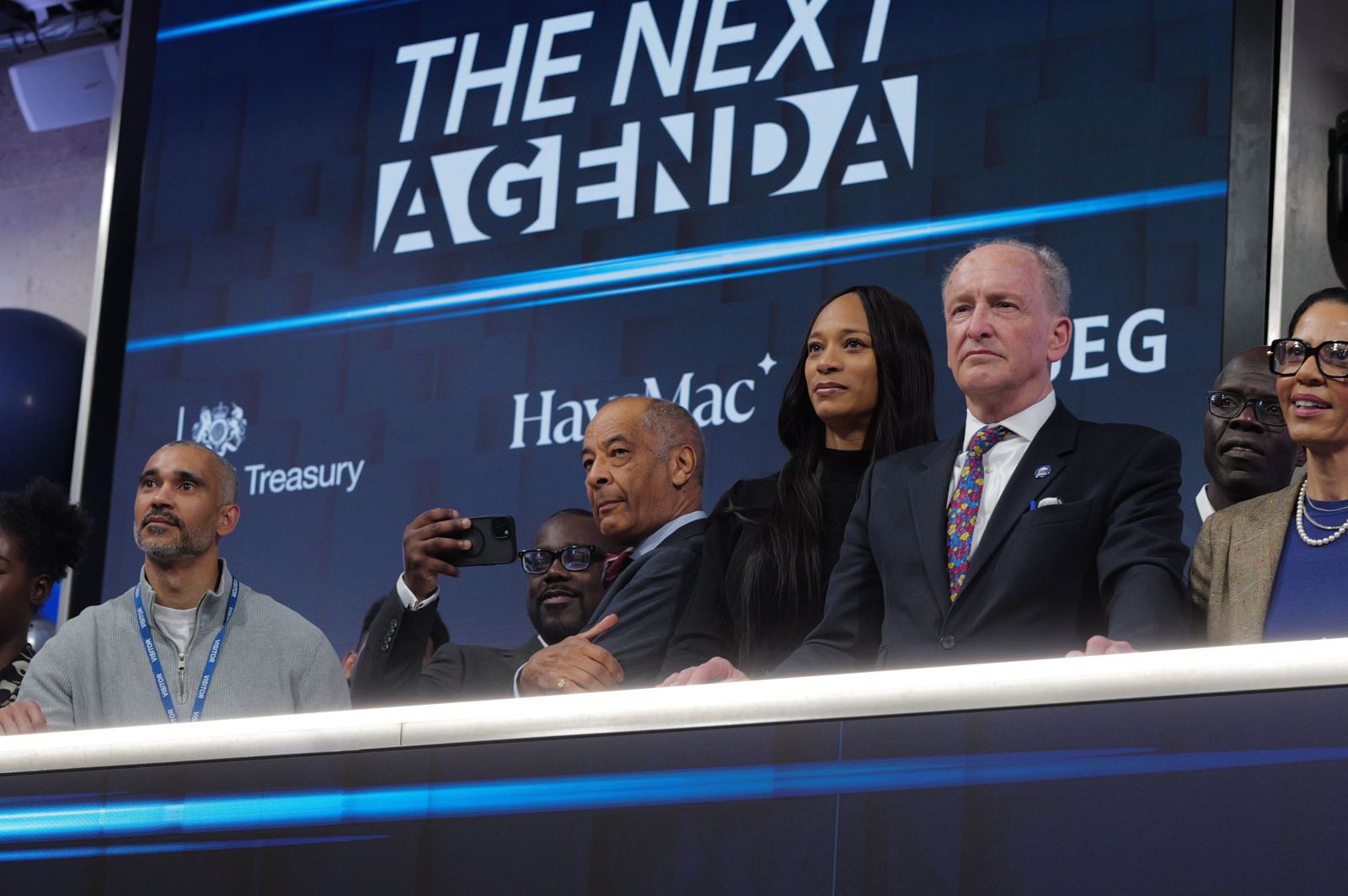 The market close moment: leaders on the balcony beneath The Next Agenda screen at the London Stock Exchange