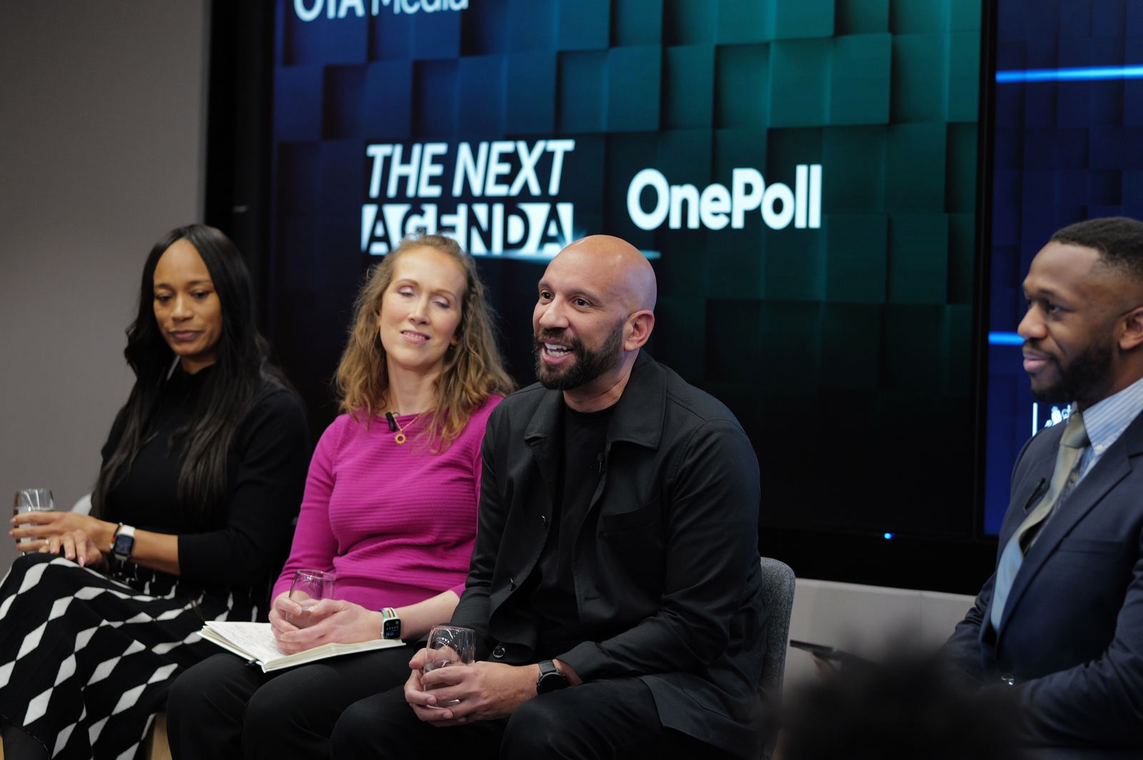 Panellists seated beneath The Next Agenda screen